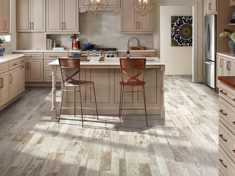kitchen island with brown chairs and beige cabinets on a hardwood floor from Stoller Floors in Orrville, OH